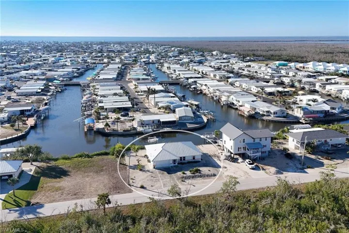 Aerial view of residential area featuring a nearby body of water