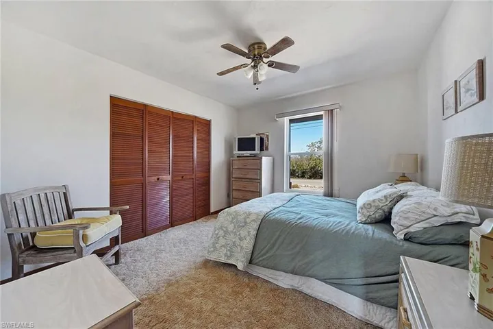 Bedroom featuring a closet, carpet floors, and ceiling fan