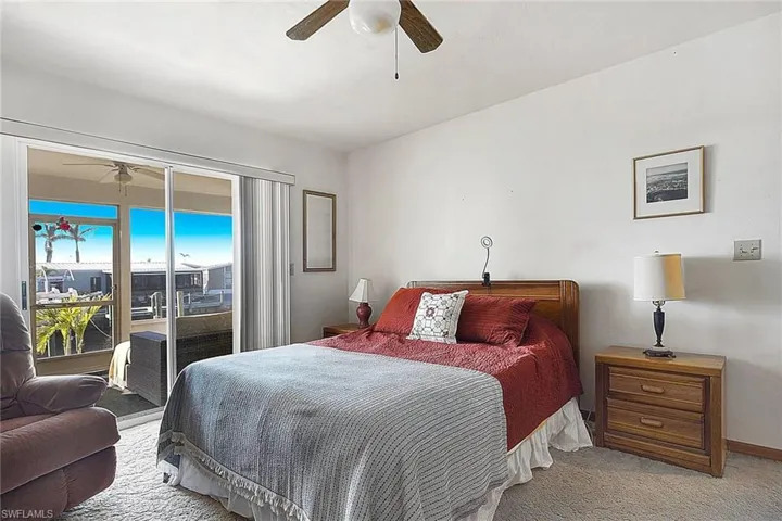Bedroom with access to outside, carpet floors, and ceiling fan