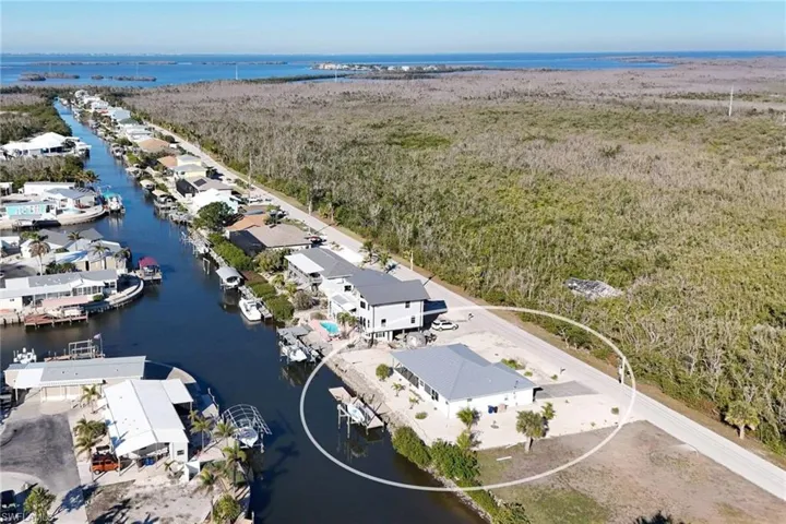 Aerial view of residential area featuring a nearby body of water