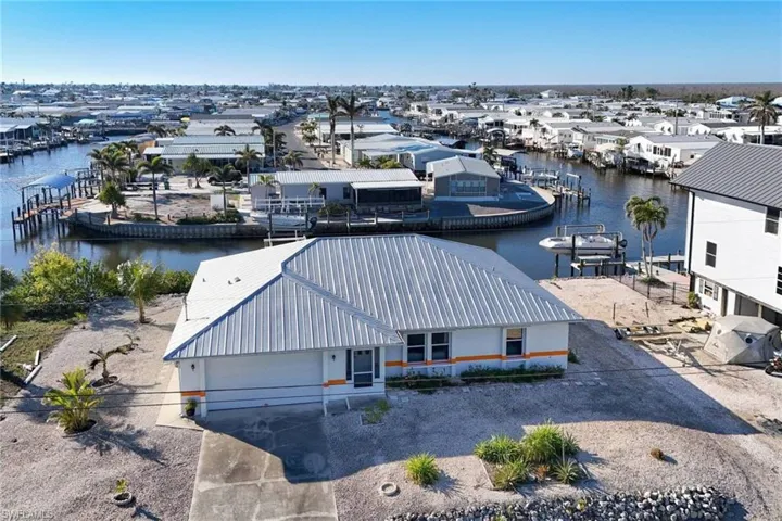 Aerial perspective of suburban area featuring a nearby body of water