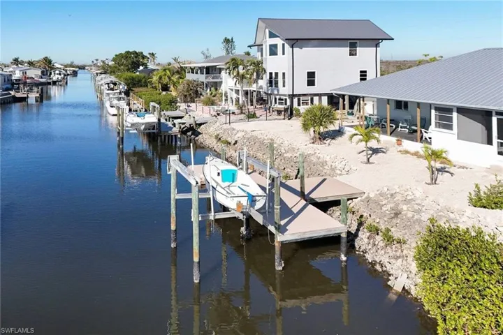 Dock area featuring boat lift and a water view