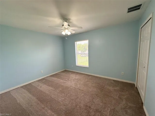 Unfurnished bedroom with carpet floors and ceiling fan