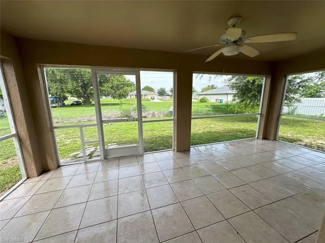 Unfurnished sunroom featuring ceiling fan