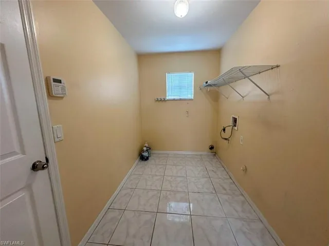 Laundry room featuring light tile patterned flooring, hookup for a gas dryer, and washer hookup