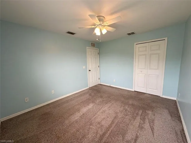 Unfurnished bedroom featuring carpet, a closet, and ceiling fan