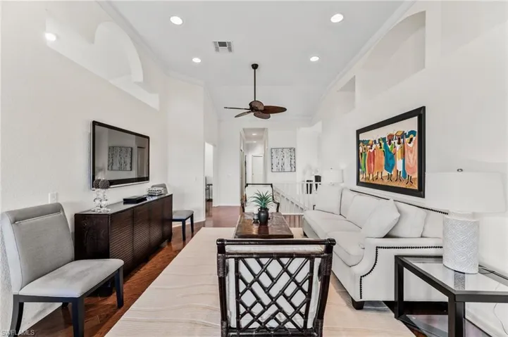 Cozy living Room with volume ceilings, decorative molding and recessed lighting