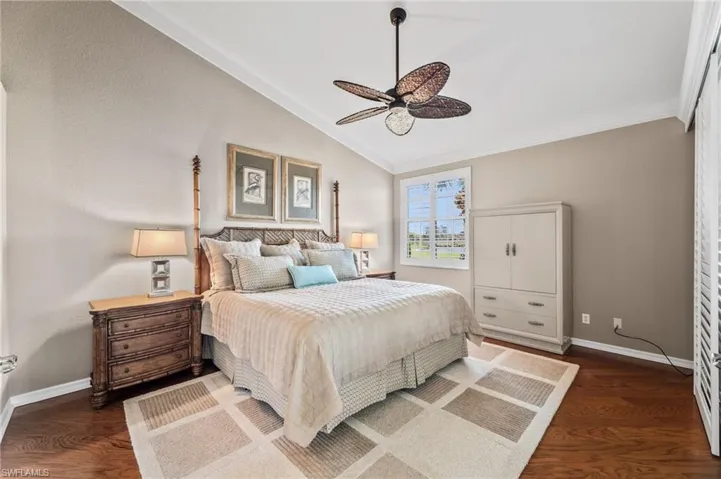 A generous primary bedroom boasts French doors, vaulted ceilings, and plantation shutters.