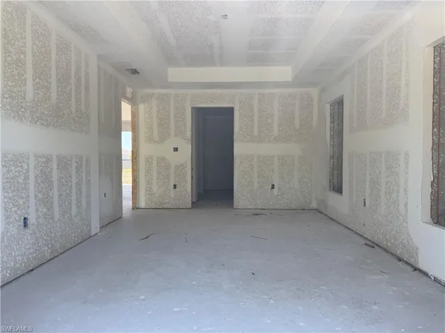 Empty room featuring a tray ceiling