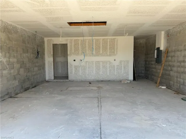Garage with electric panel and concrete block wall