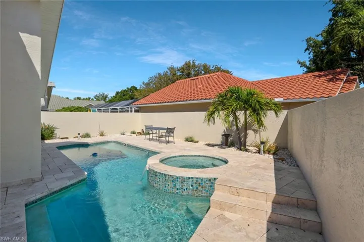 Secluded back yard with plenty of space for lounging pool side.