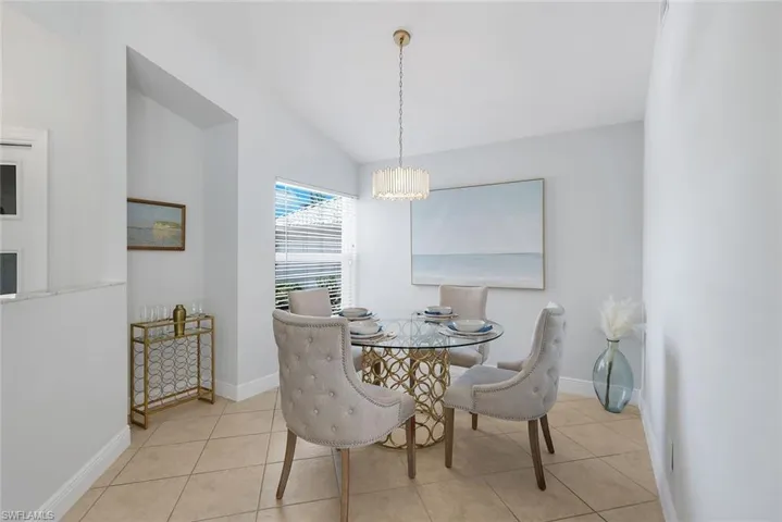 Updated spacious kitchen with white shaker cabinetry, quartz counters and stainless steel appliances