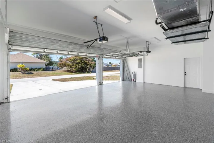 Garage with electric panel and a garage door opener