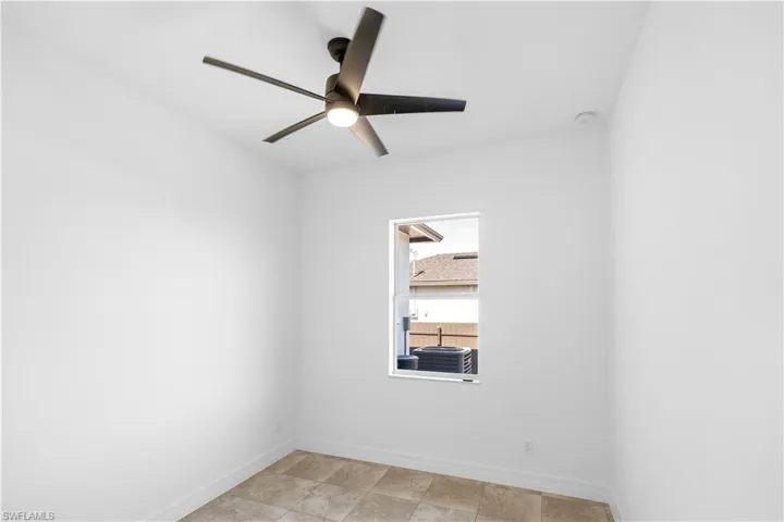 Empty room with baseboards and ceiling fan