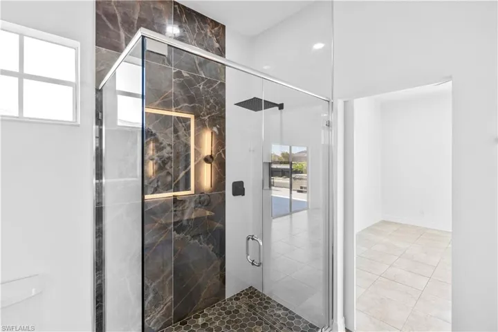 Bathroom featuring a marble finish shower