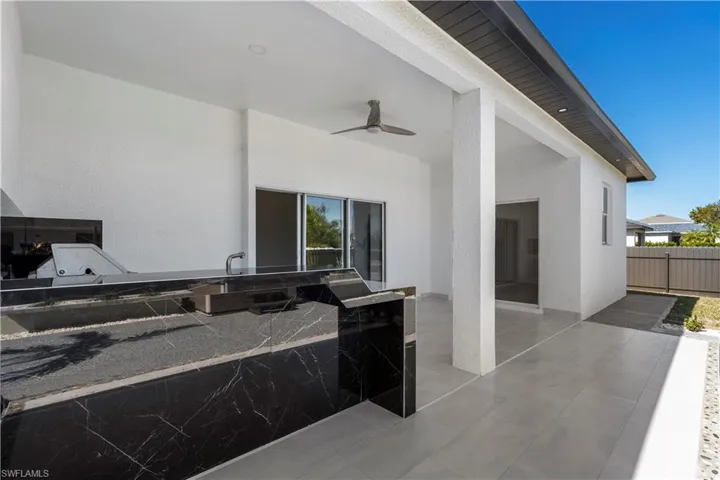View of patio with ceiling fan and exterior kitchen