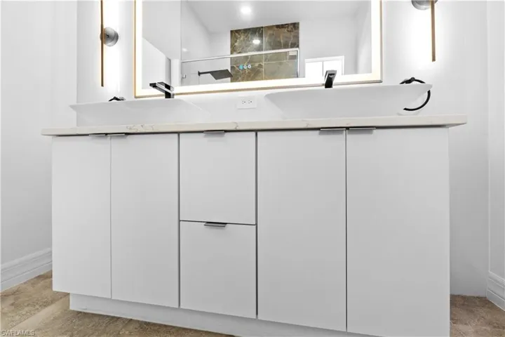 Bathroom with double vanity and a shower