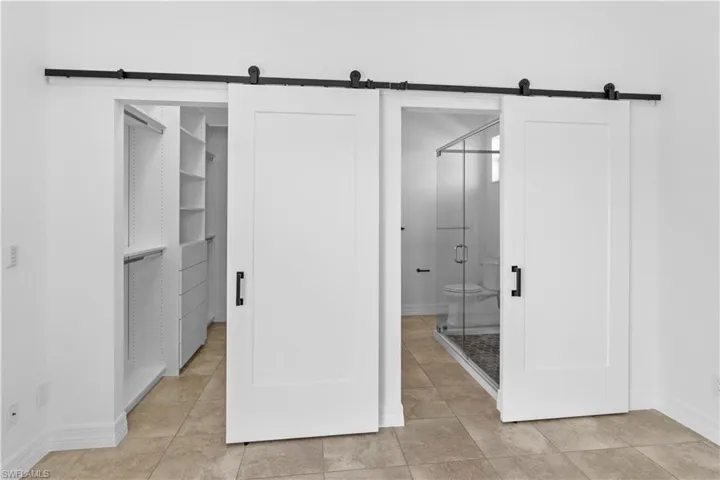 Bathroom featuring baseboards and a shower stall