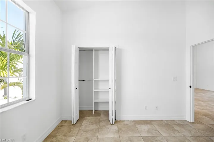 Unfurnished bedroom featuring baseboards and a closet