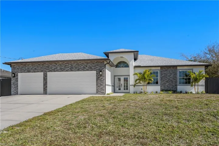 View of front of home featuring french doors, stucco siding, a garage, concrete driveway, and a shingled roof