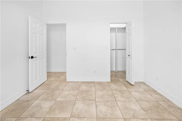 Unfurnished bedroom with a walk in closet