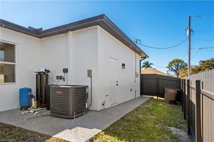 View of property exterior featuring stucco siding and a fenced backyard