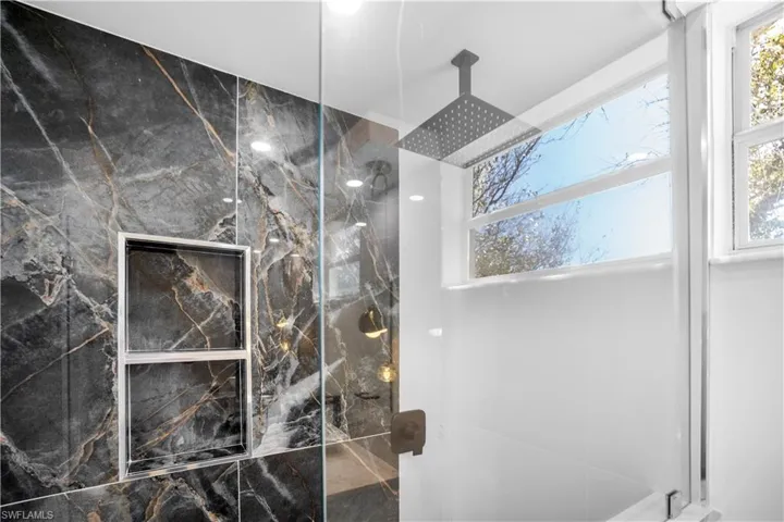Bathroom featuring a marble finish shower