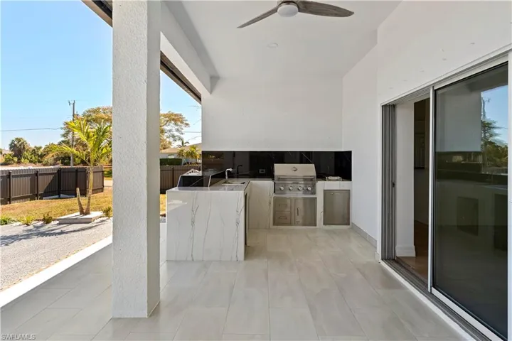 View of patio / terrace featuring area for grilling and ceiling fan