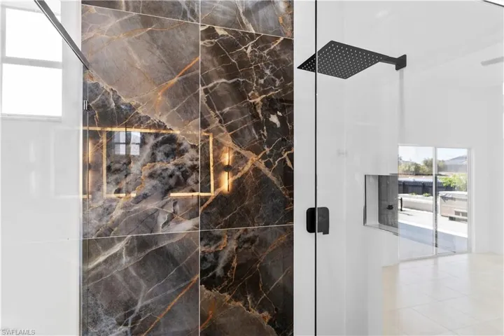 Bathroom with a marble finish shower