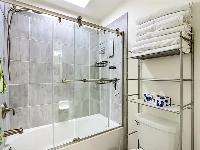 2nd floor Jack and Jill Bathroom featuring a tub/shower combination with sliding glass doors.  Guest Bedrooms #2 and #3 share this Bathroom