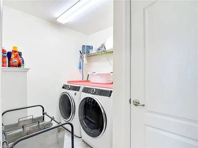 Utility room featuring two front-loading laundry machines located on the 2nd floor