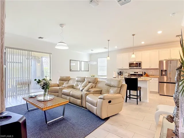 Open-concept living space with light wood-finish flooring