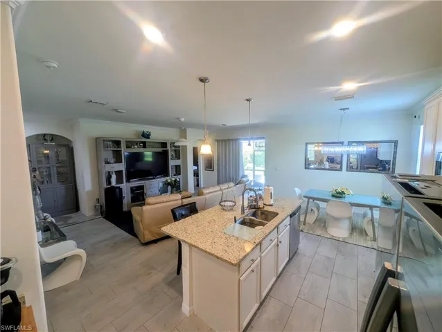 Expansive kitchen island with granite countertop and dual basin sink