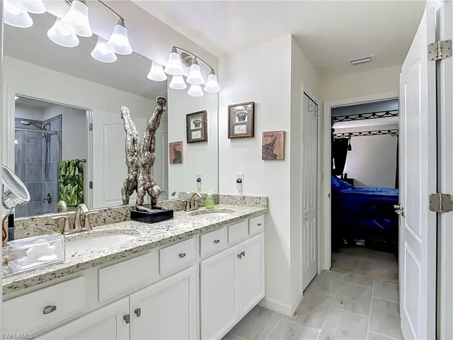 2nd floor Jack and Jill Bathroom featuring a tub/shower combination with a Granite Countertop and dual sinks.  Bedrooms #2 and #3 share this Bathroom
