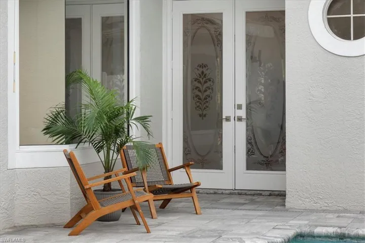 Doorway to property with french doors and stucco siding