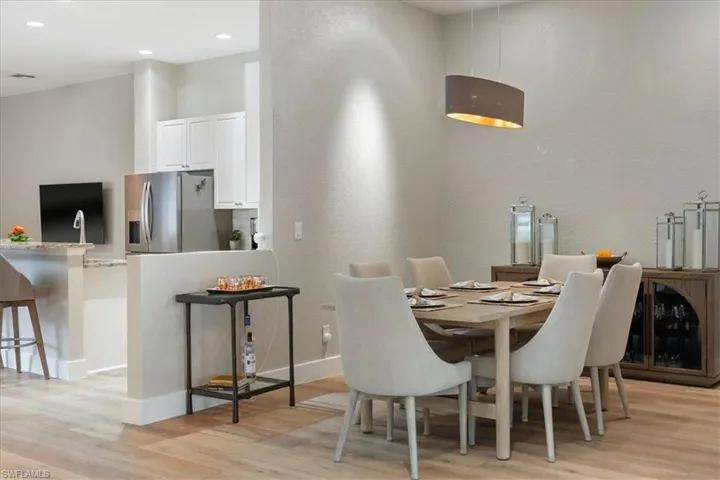Dining area featuring light wood-style floors, recessed lighting, and baseboards