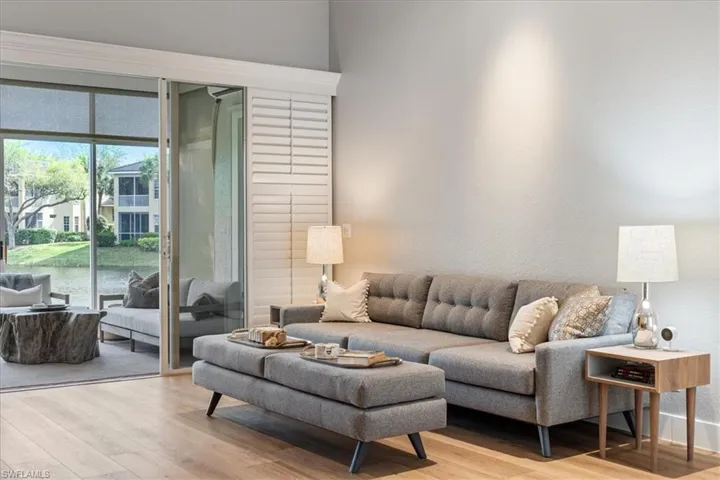 Living room featuring a water view and light wood-style floors