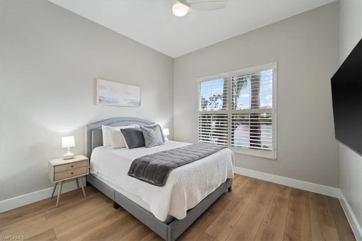 Bedroom featuring hardwood / wood-style flooring and baseboards