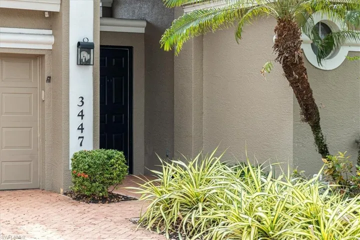 Property entrance featuring stucco siding