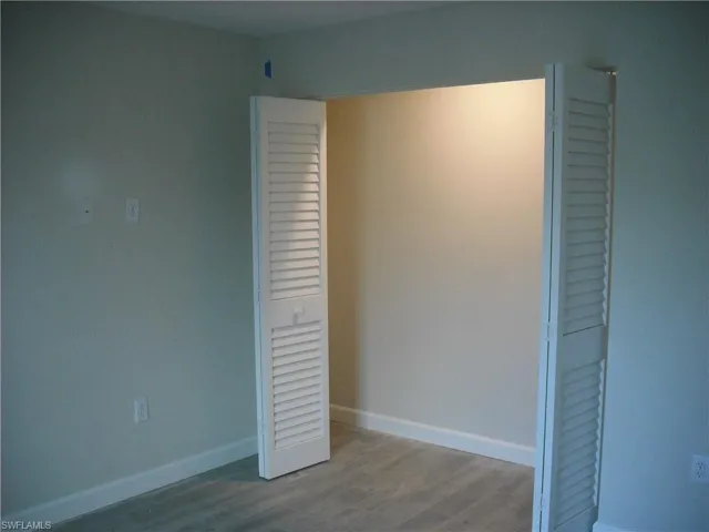 Unfurnished bedroom featuring a closet and light hardwood / wood-style flooring