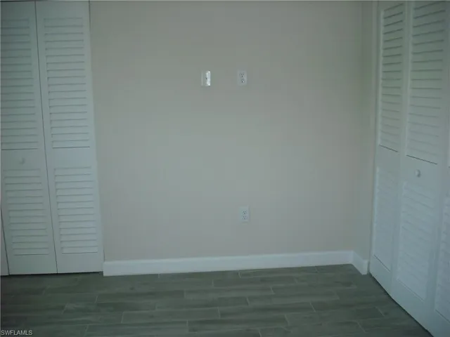 Unfurnished bedroom with wood finish floors and a closet