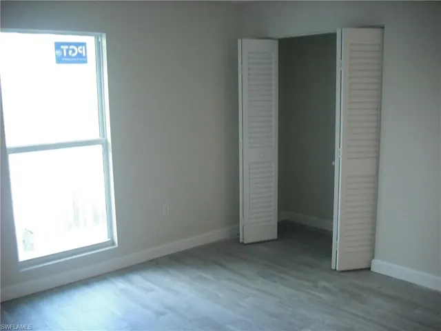 Unfurnished bedroom with a closet and light wood-type flooring