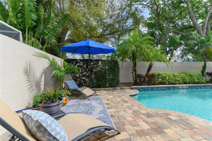 View of pool with a fenced backyard and patio surround