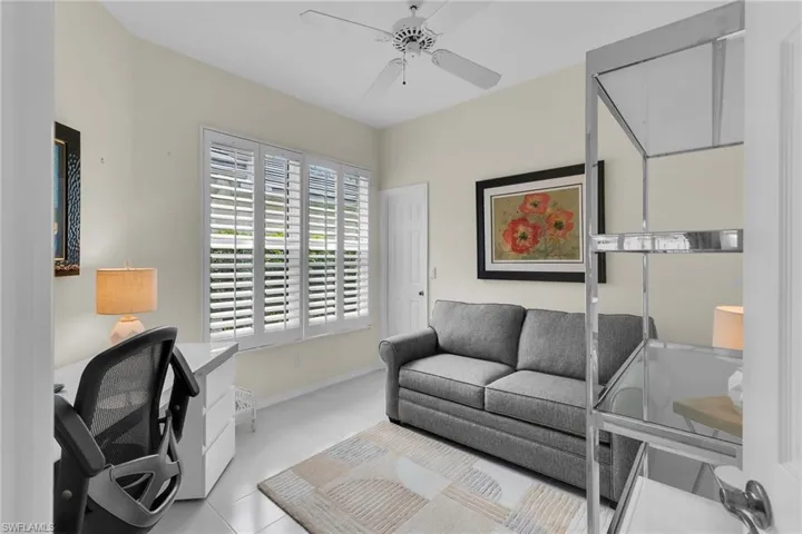 Office space featuring ceiling fan and light tile patterned floors