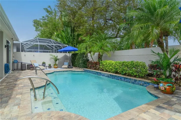 View of pool featuring a fenced backyard, patio surround, a lanai, and a sunroom