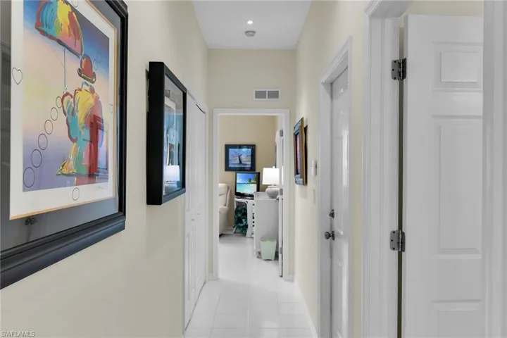Hallway with light tile patterned floors