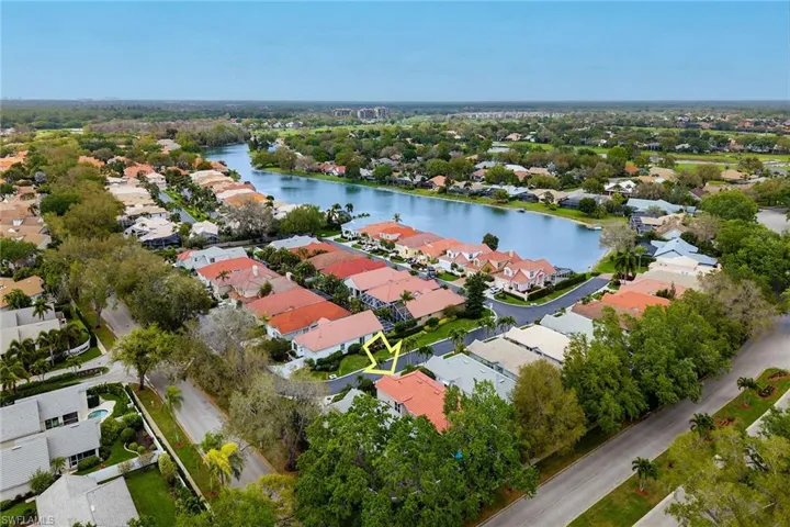 Aerial perspective of suburban area featuring a large body of water