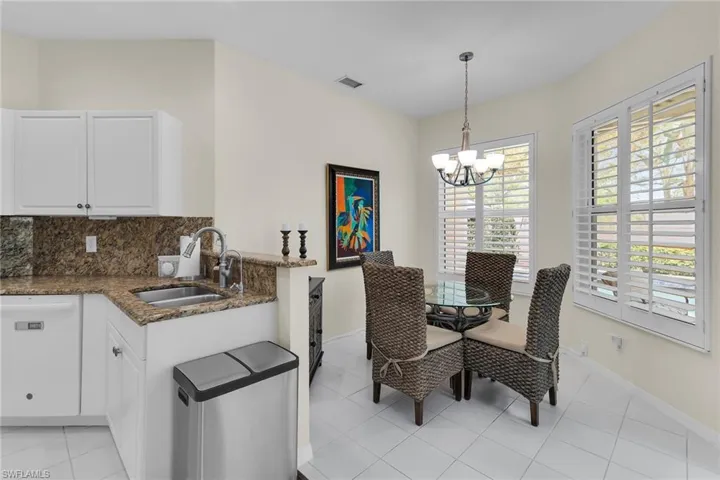 Dining room with a chandelier and light tile patterned flooring