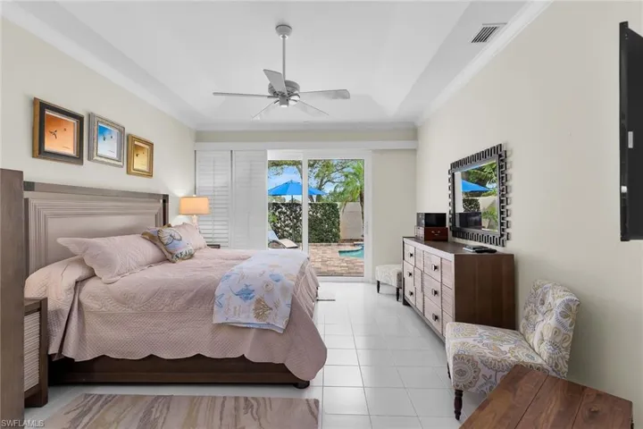 Bedroom with access to outside, crown molding, ceiling fan, and light tile patterned floors