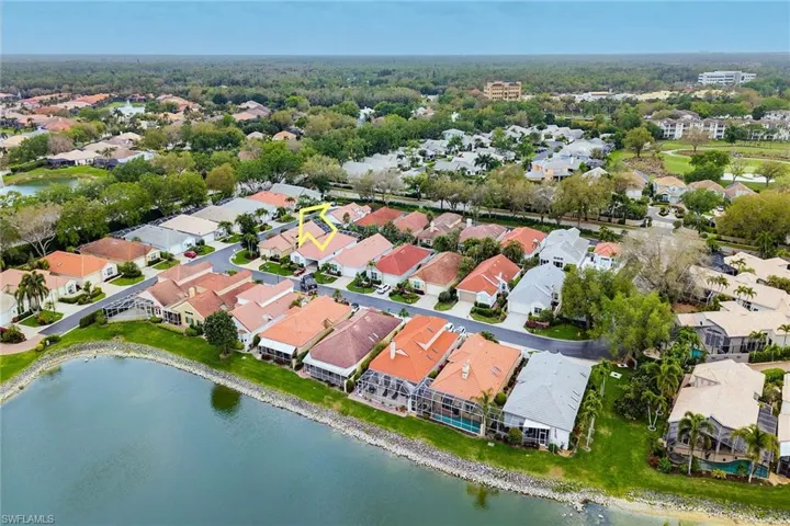Aerial view of property and surrounding area with nearby suburban area